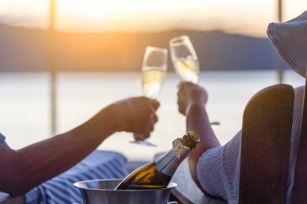 couple-relaxing-and-drinking-champagne-on-deck